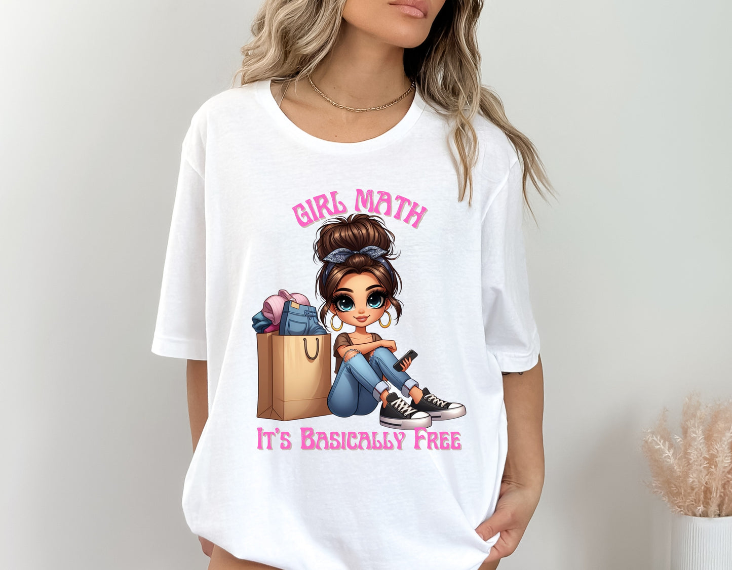 Model wearing white Bella Canvas unisex t-shirt with cartoon girl, shopping bags, and pink text that reads “Girl Math – It’s Basically Free” – Oaklieten woman-owned brand