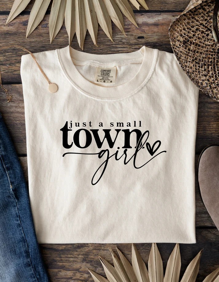 Cream Gildan Softstyle unisex t-shirt with “Just a Small Town Girl” text and heart graphic – Oaklieten woman-owned brand