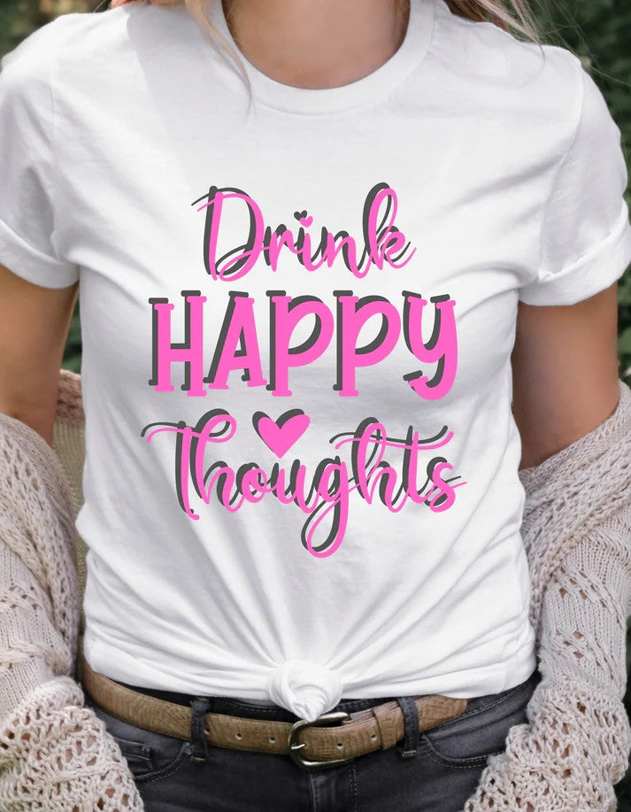 Woman wearing a white Gildan T-shirt with bold pink text reading “Drink Happy Thoughts,” paired with jeans and a cozy cardigan.
