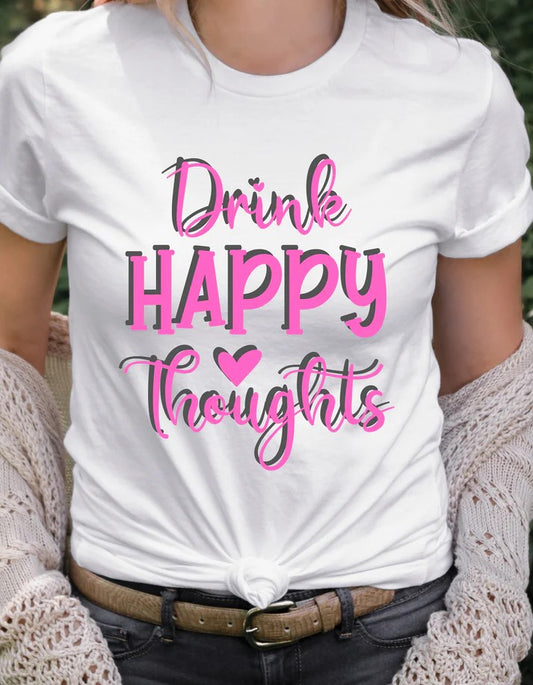 Woman wearing a white Gildan T-shirt with bold pink text reading “Drink Happy Thoughts,” paired with jeans and a cozy cardigan.