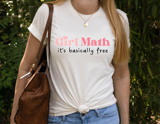 Woman wearing a Girl Math – It’s Basically Free shirt, funny trendy graphic tee for women, white t-shirt with pink and black lettering.