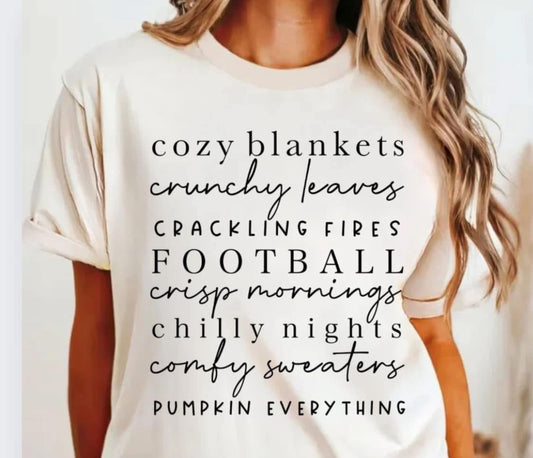 Cozy Blankets Fall Vibes T-Shirt – Autumn Graphic Tee with cozy blankets, crunchy leaves, football, and pumpkin everything text, cream color, women's seasonal shirt